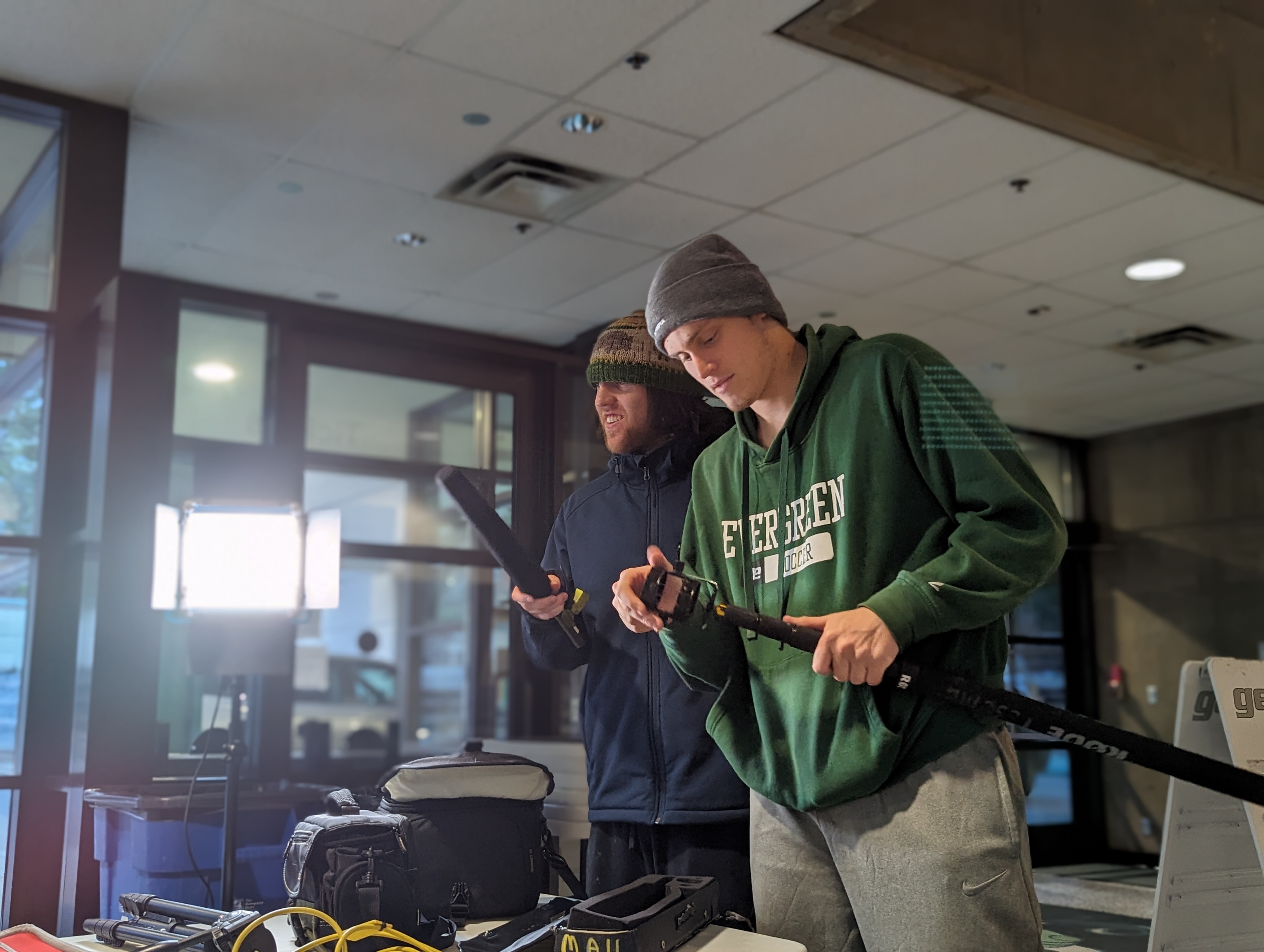 A photograph of two filmmakers setting up equipment.