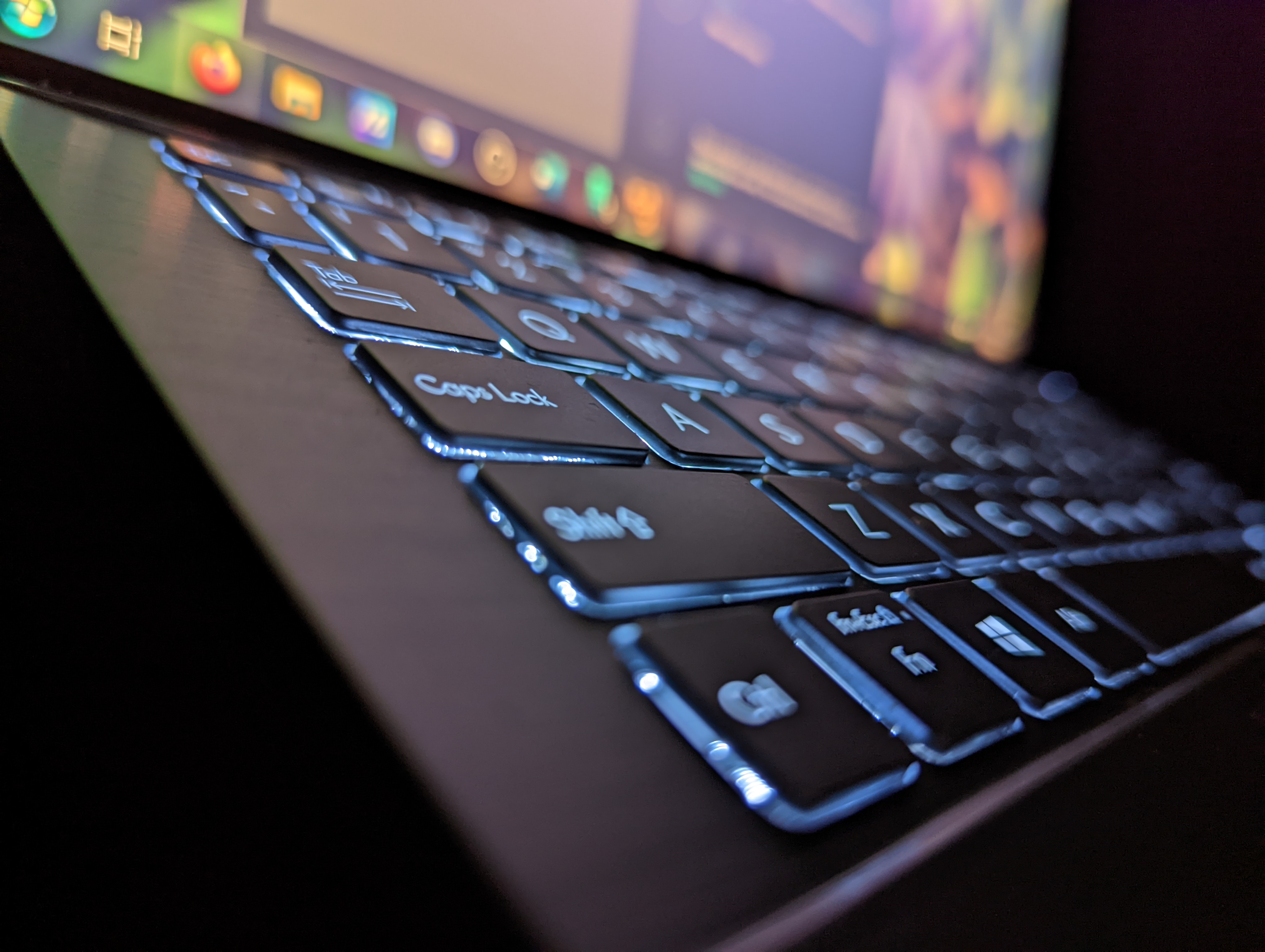 A macro photograph of a keyboard with backlit keys.